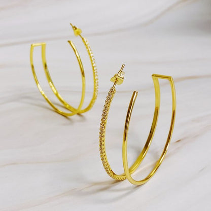 Double Open Top Hoop Earrings in gold with cubic zirconia sparkle displayed on marble background