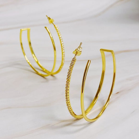 Double Open Top Hoop Earrings in gold with cubic zirconia sparkle displayed on marble background
