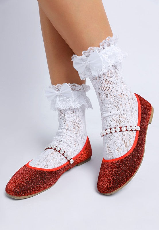 Top front view of red Corphee Pearl Strapped Glitter Ballerinas being worn with pearl strap detail.