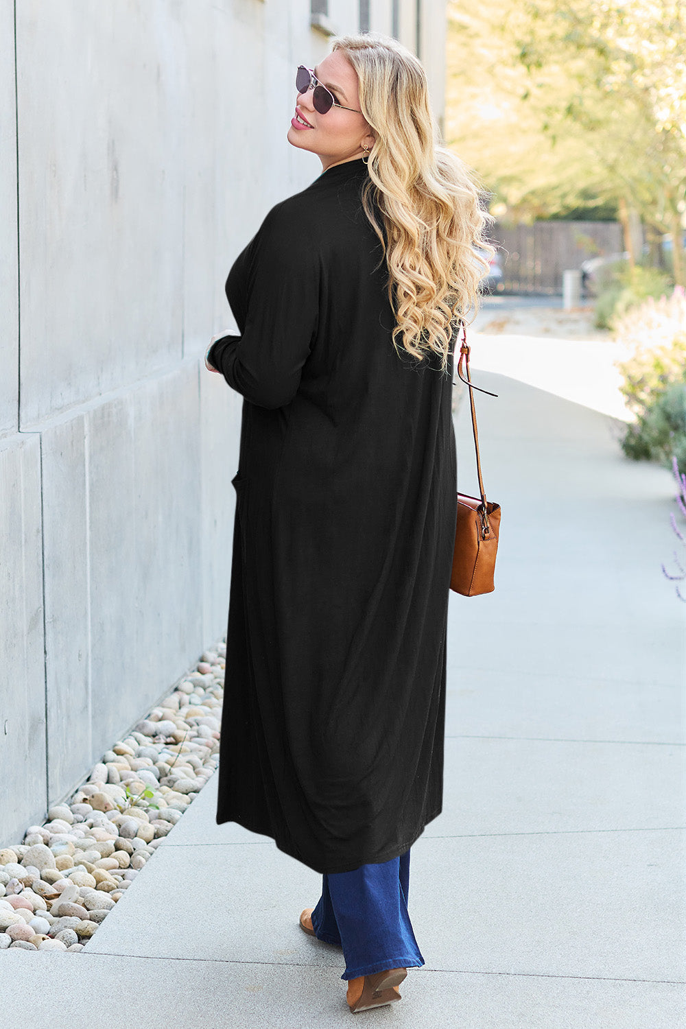 Black open-front long-sleeve cover-up with a flowy design and pockets, perfect for layering on breezy days.