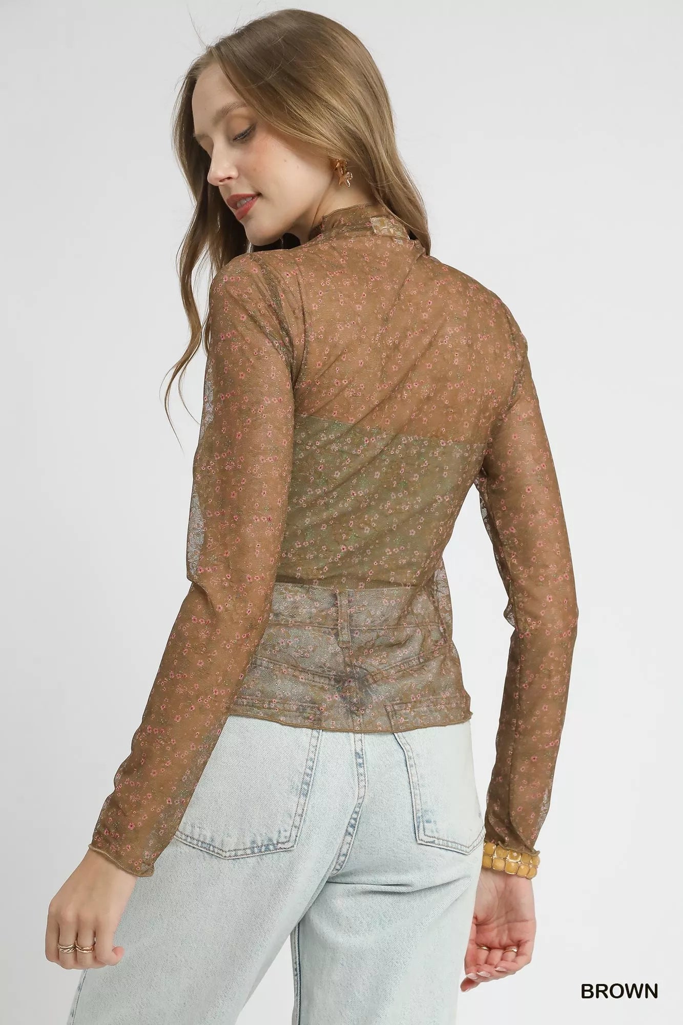 Back view of brown lace mesh top with mock neck and delicate floral design.