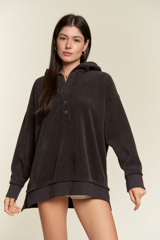 Model wearing charcoal Kenzie Plus Size Hooded Sweatshirt, showing relaxed hem and buttons.