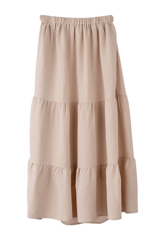 Tiered maxi skirt with elastic waistband in beige. Flowy silhouett, lined for full coverage.