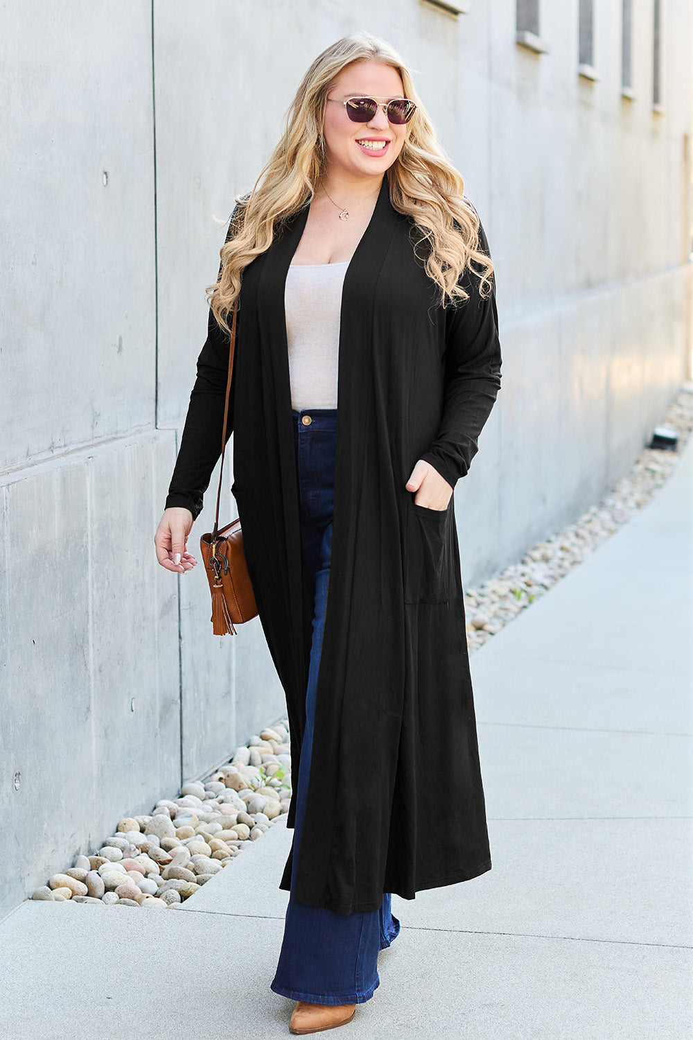 Black open-front long-sleeve cover-up with a flowy design and pockets, perfect for layering on breezy days.