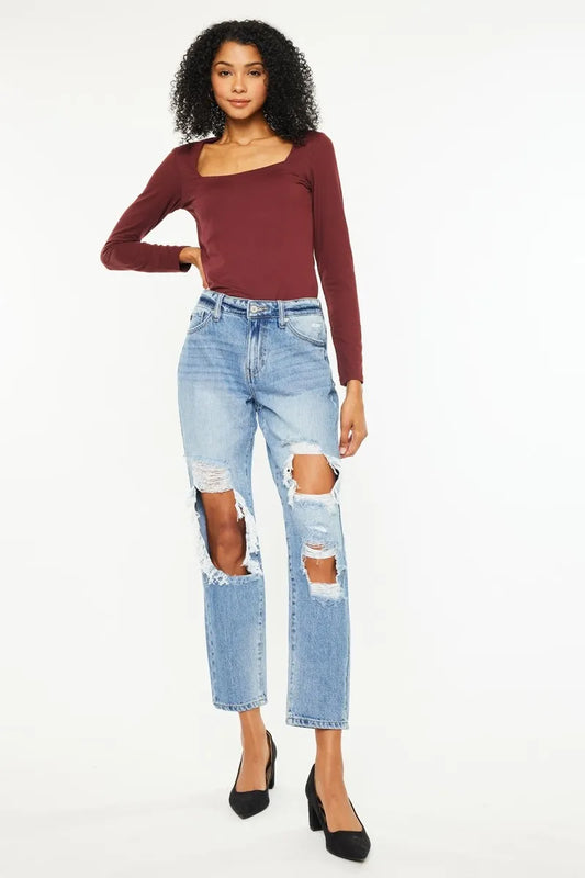 ull body view of model wearing Millie high rise distressed cropped jeans styled with pumps and a long sleeve top, showcasing heavy distressing and raw hem.