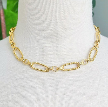 Necklace displayed on mannequin, showcasing bold alternating cable links