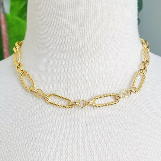 Necklace displayed on mannequin, showcasing bold alternating cable links