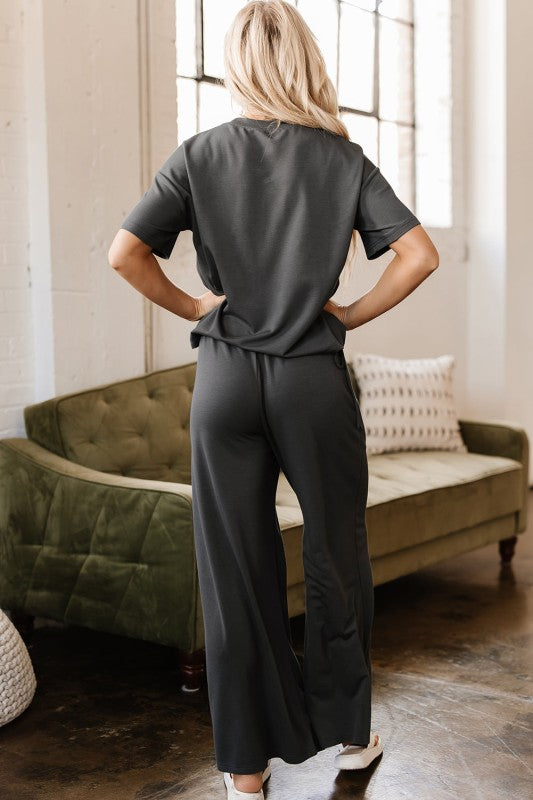 Back view of Dallas Two-Piece Set in dark gray showing relaxed drape of pants and tee
