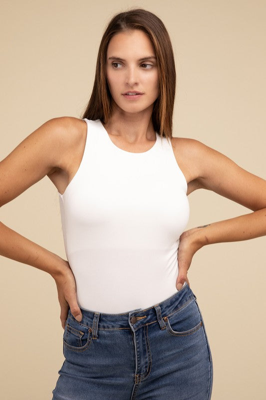 Sleeveless bodysuit in bone with a boat neckline, padded bodice, and removable bra pads for adjustable comfort.