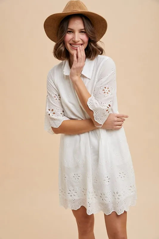 Front view of the Kiaan Embroidered Mini Shirt Dress in ivory, showcasing scalloped hem and eyelet embroidery.