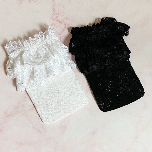 Folded set of black and white lace socks stacked together showing lace trim.