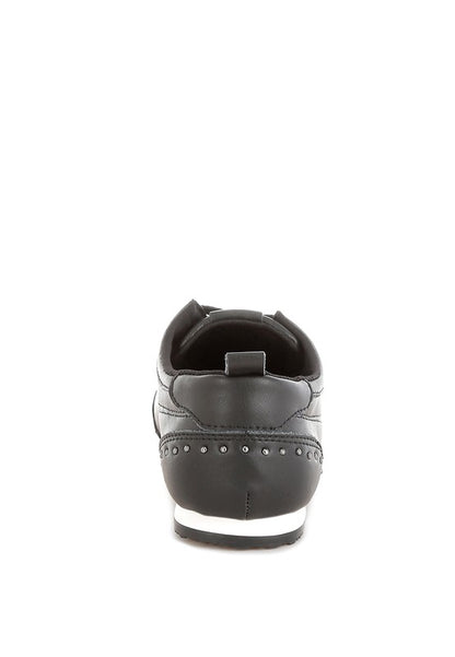 Black Odaya Studded Leather Sneakers by Rag Company, back view showing pull tab and contrast sole detail.
