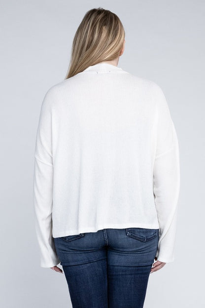 Plus size model wearing Raya Curvy Plus Drop Shoulder Top in off white with mock neck, back view.