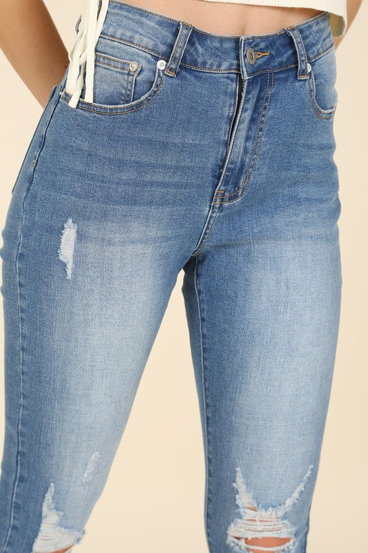 Dark wash distressed skinny jeans with high waist, zip fly, 5-pocket design, and stretch for comfort.