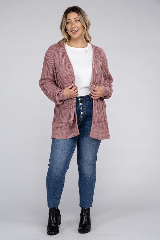 Curvy plus-size waffle-pattern open cardigan sweater in light rose, with long sleeves, oversized fit, and pockets.