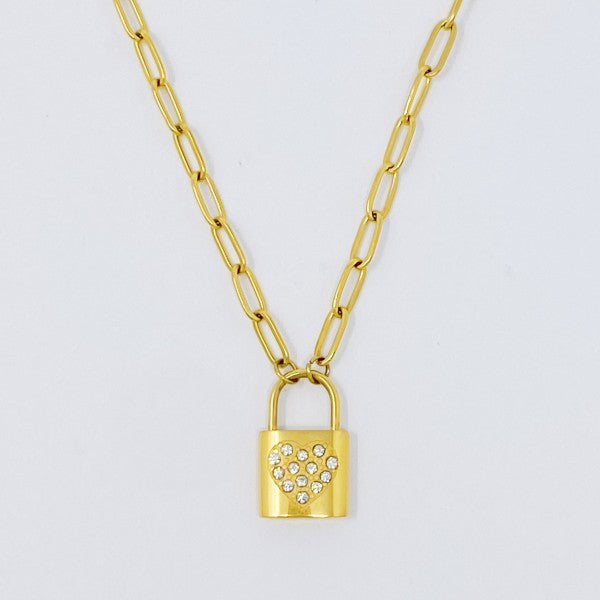 Locked In Shiny Heart Necklace flat lay with gold link chain and lock pendant featuring a shiny heart detail