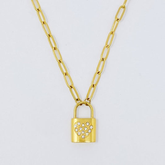 Locked In Shiny Heart Necklace flat lay with gold link chain and lock pendant featuring a shiny heart detail