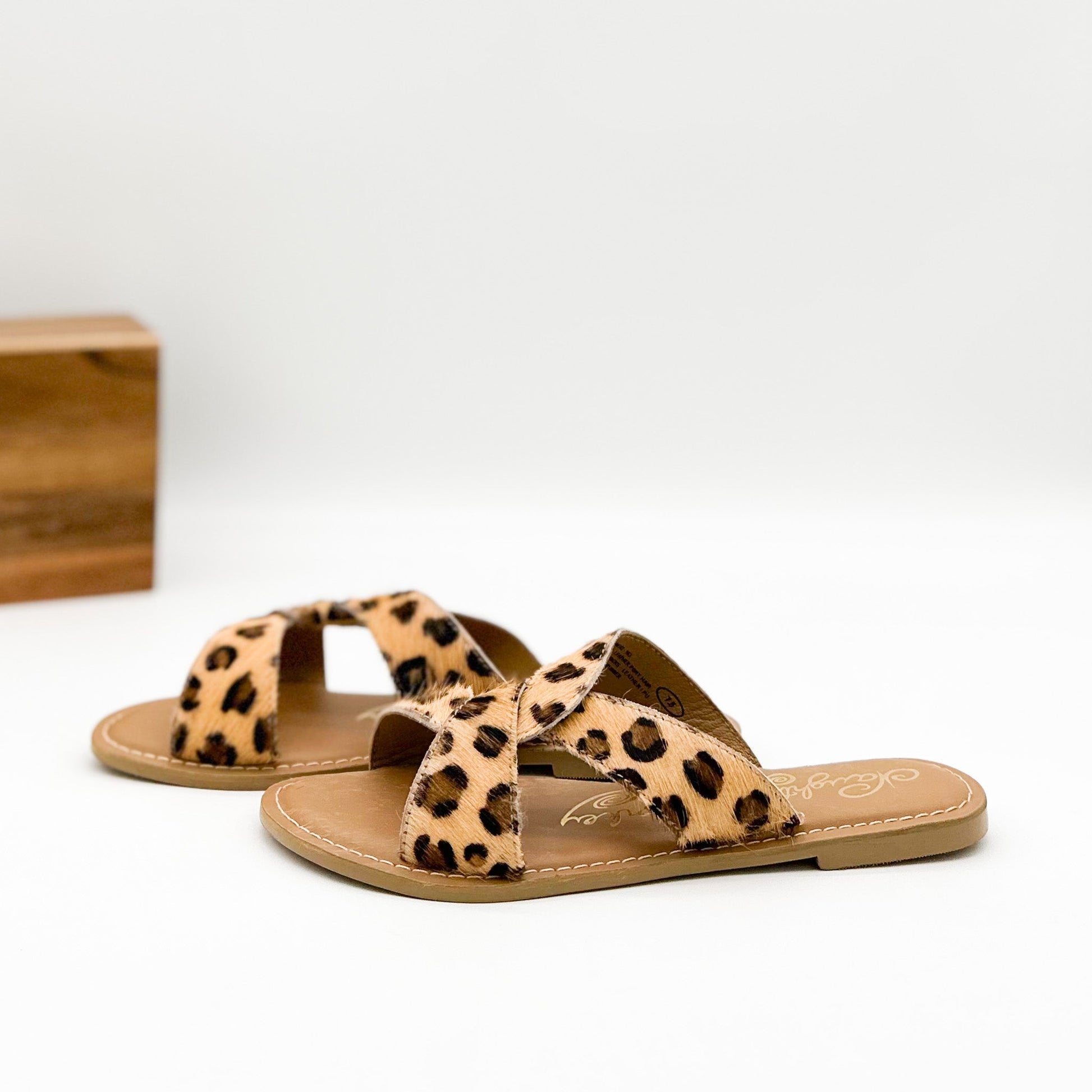 Naughty Monkey Conga leopard print knotted slide sandal with open toe and flat heel—true to size.