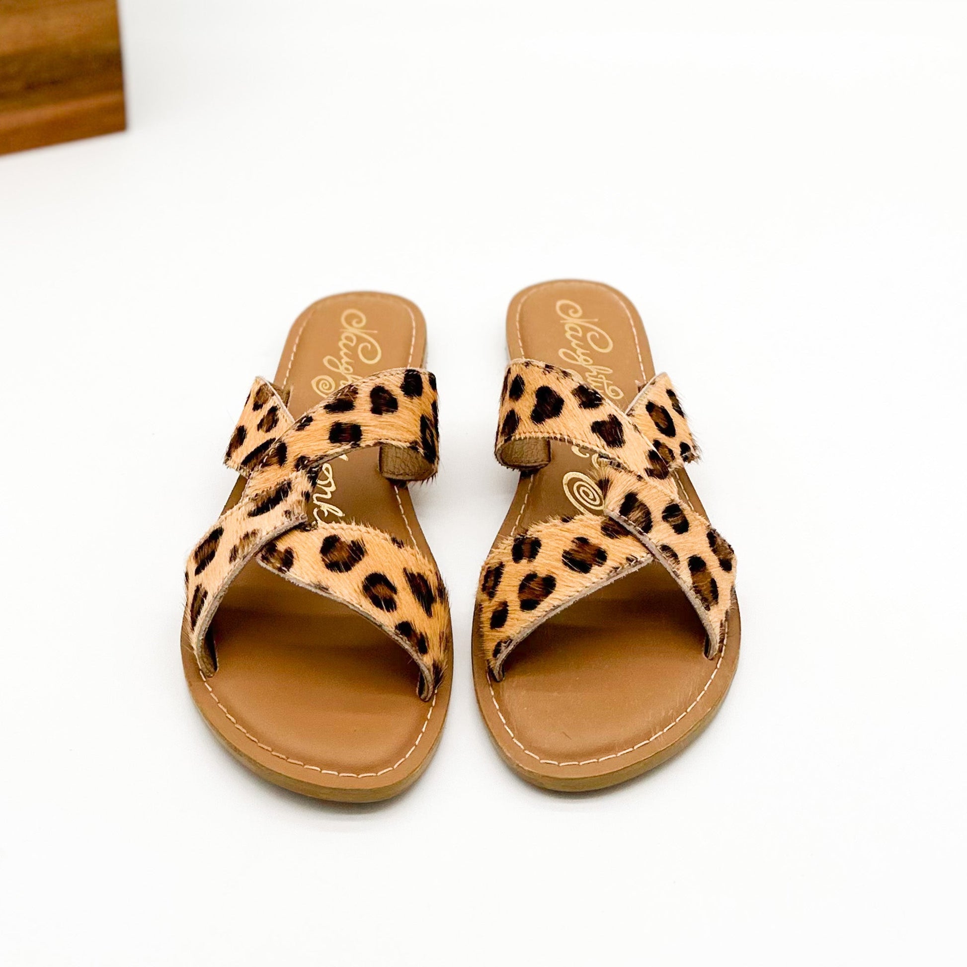 Conga sandal with knotted design, open toe, and flat heel—features genuine leather footbed and leopard print.