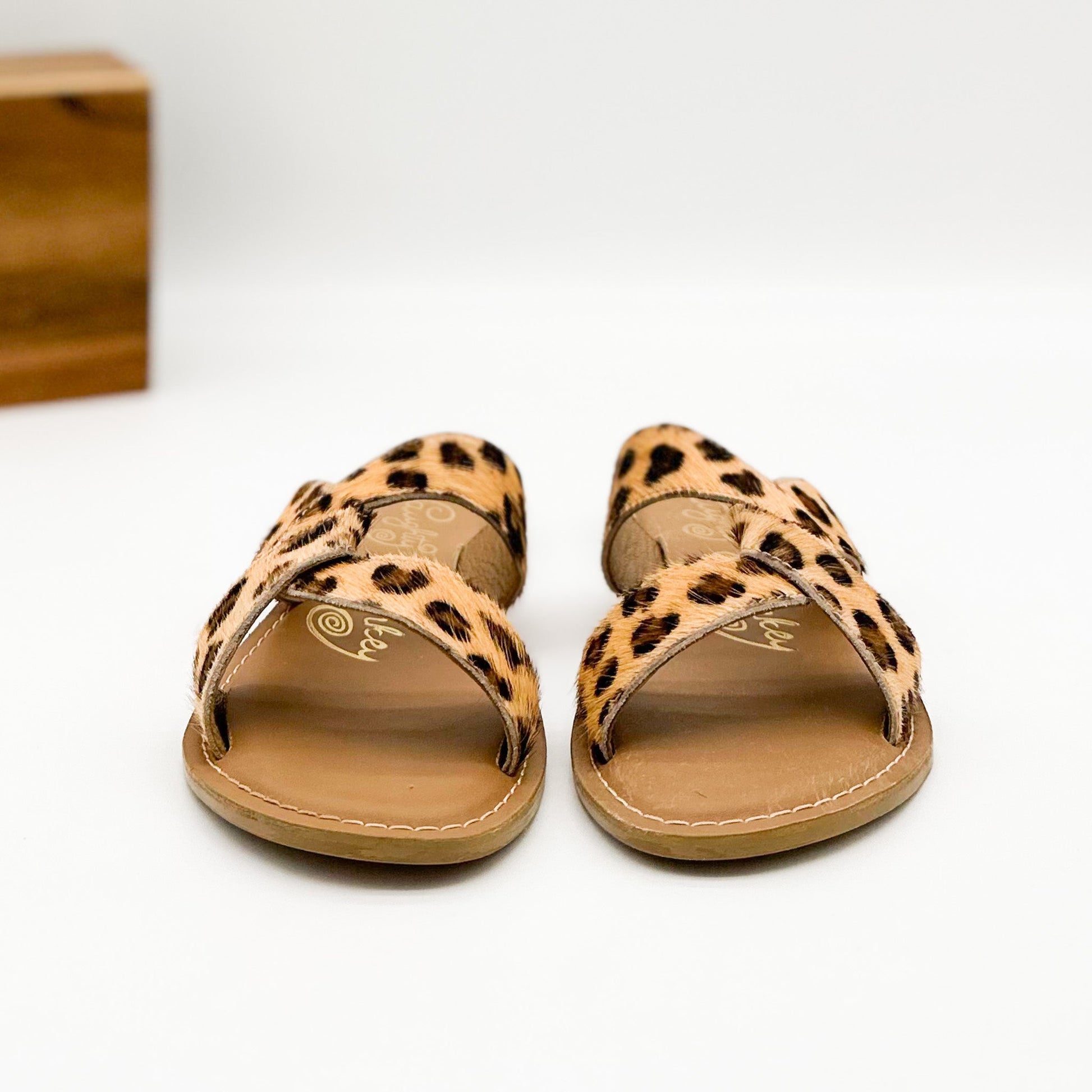 Naughty Monkey knotted leopard slide sandals with hide upper and comfortable leather sole.