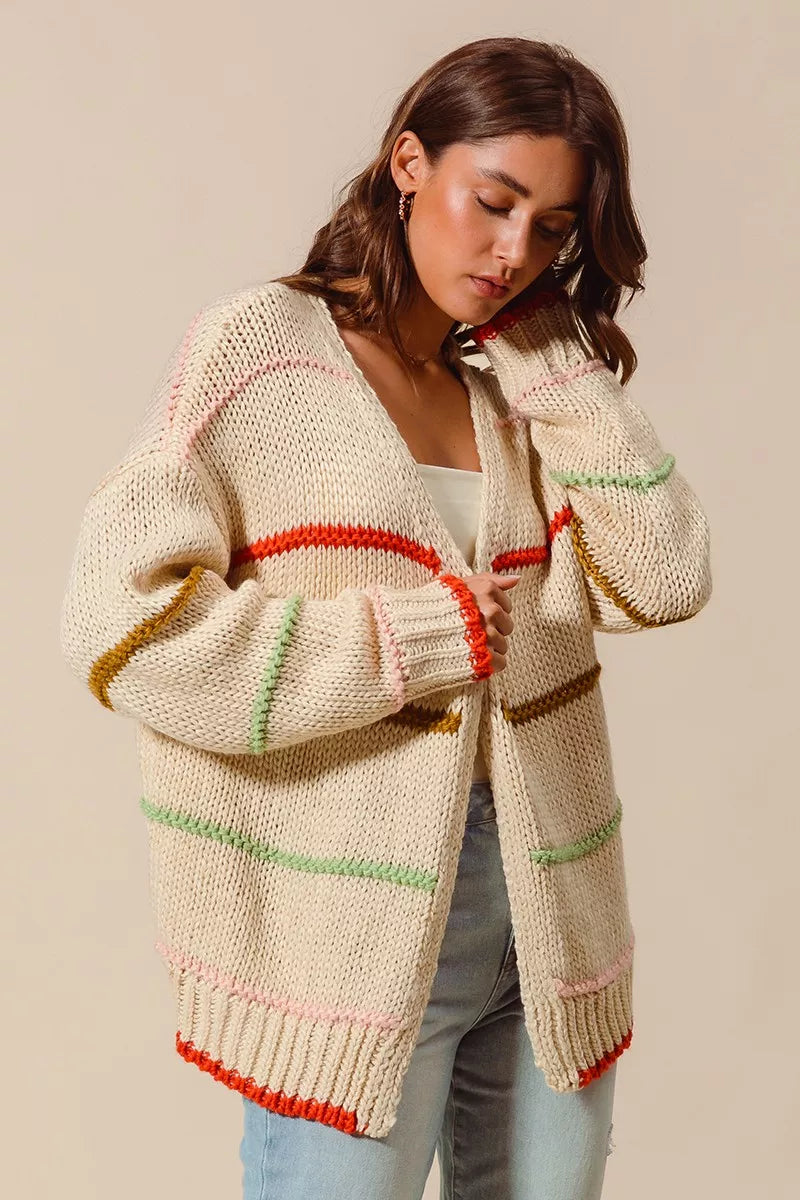 Model wearing Angelina Cardigan showing colorful striped knit front view.