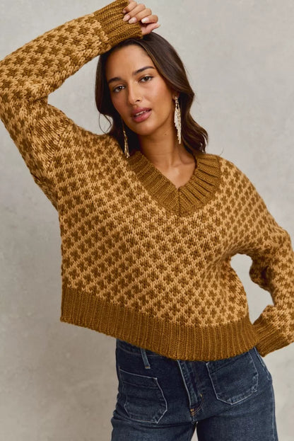 Lifestyle look: model layering Chloe caramel V-neck sweater over collared shirt, casual chic style.