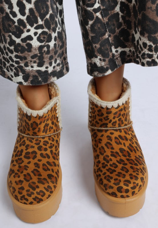 Model wearing Rochas Leopard Print Snow Boots top view with faux suede finish and scalloped trim.