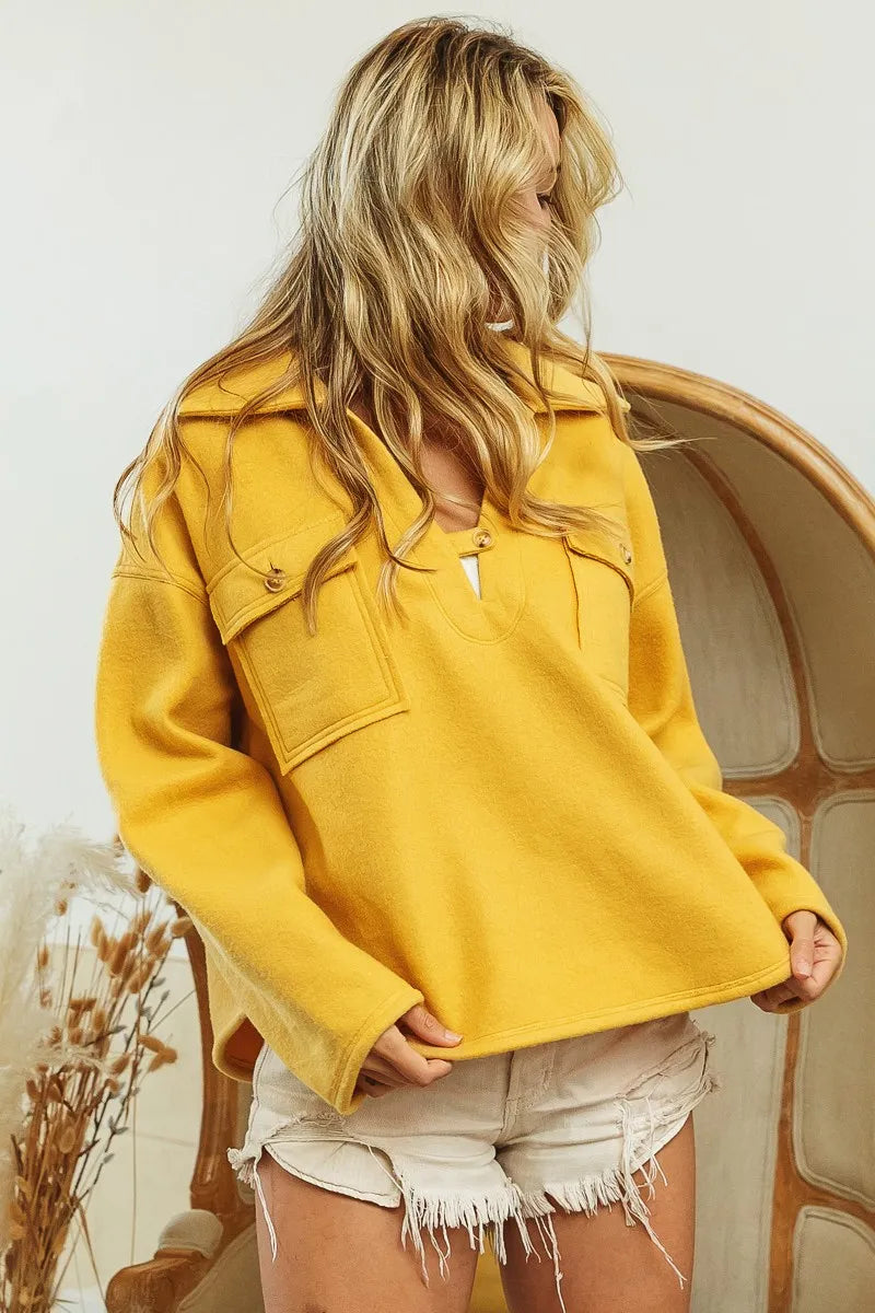 Side angle of collared fleece sweatshirt in honey mustard with long sleeves and pocket details.
