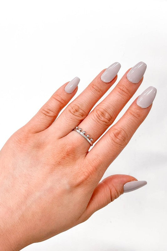 Silver Bump Adjustable Ring on woman’s hand.