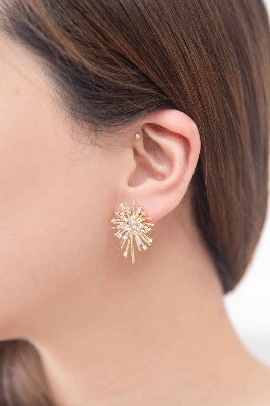 Woman wearing Flare Post Earrings with gold burst and small stones