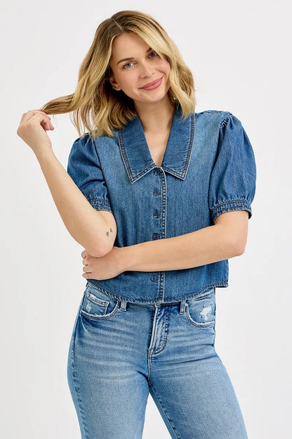 Model wearing Alexa cropped puff sleeve denim shirt styled with high-waisted pants.