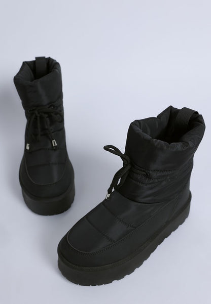 Pair of Pacos Snow Boots in black displayed at front and side angle.