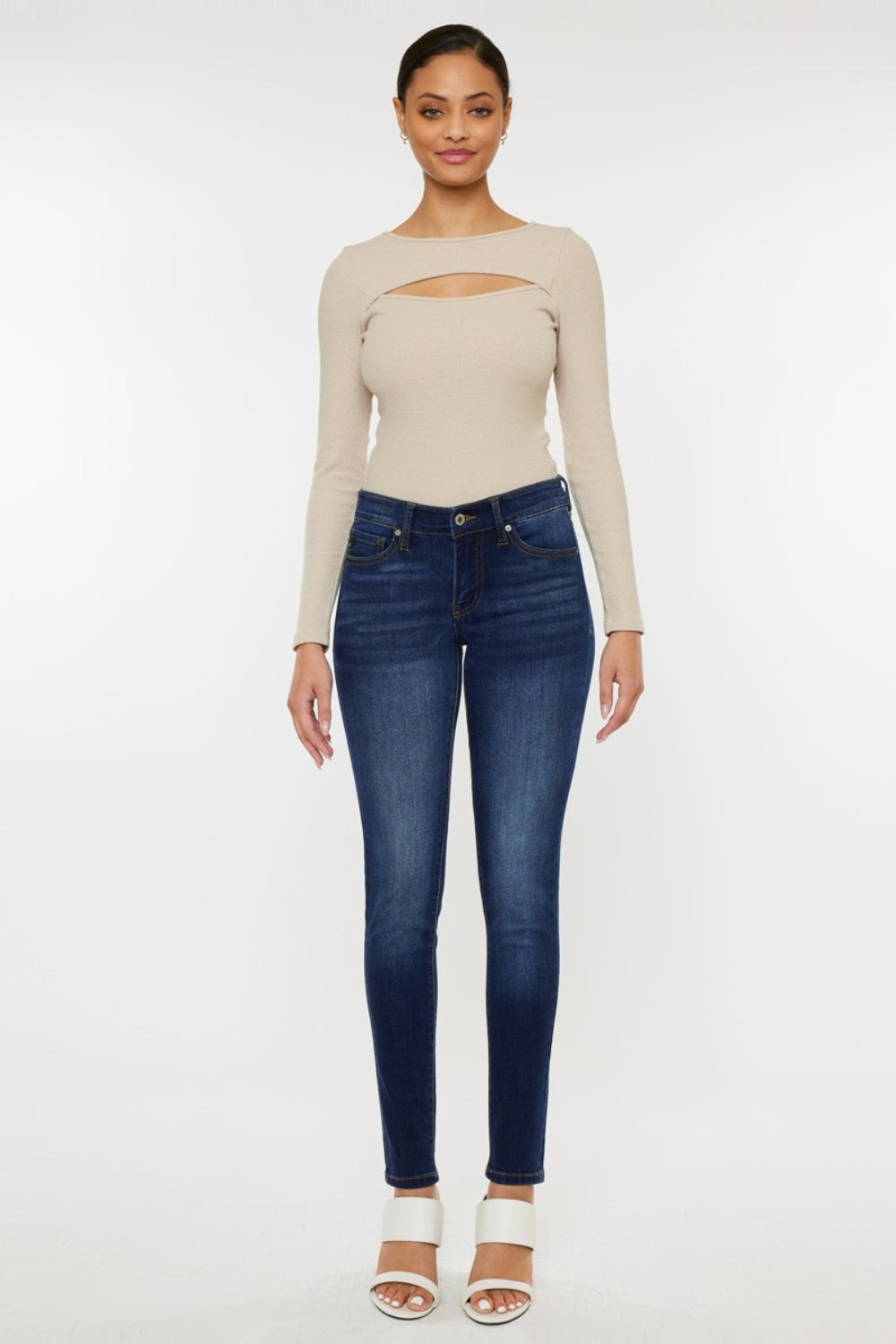 Mid rise gradient skinny jeans with a dark wash. Slightly stretchy, with pockets and a zip fly closure.