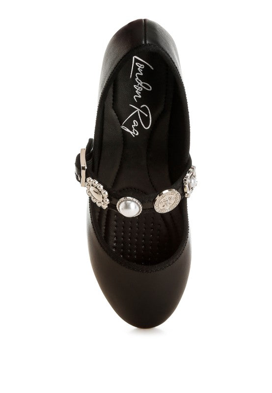 Top view of black Kavana Mary Jane Flats showcasing the embellished charm strap and round toe design.
