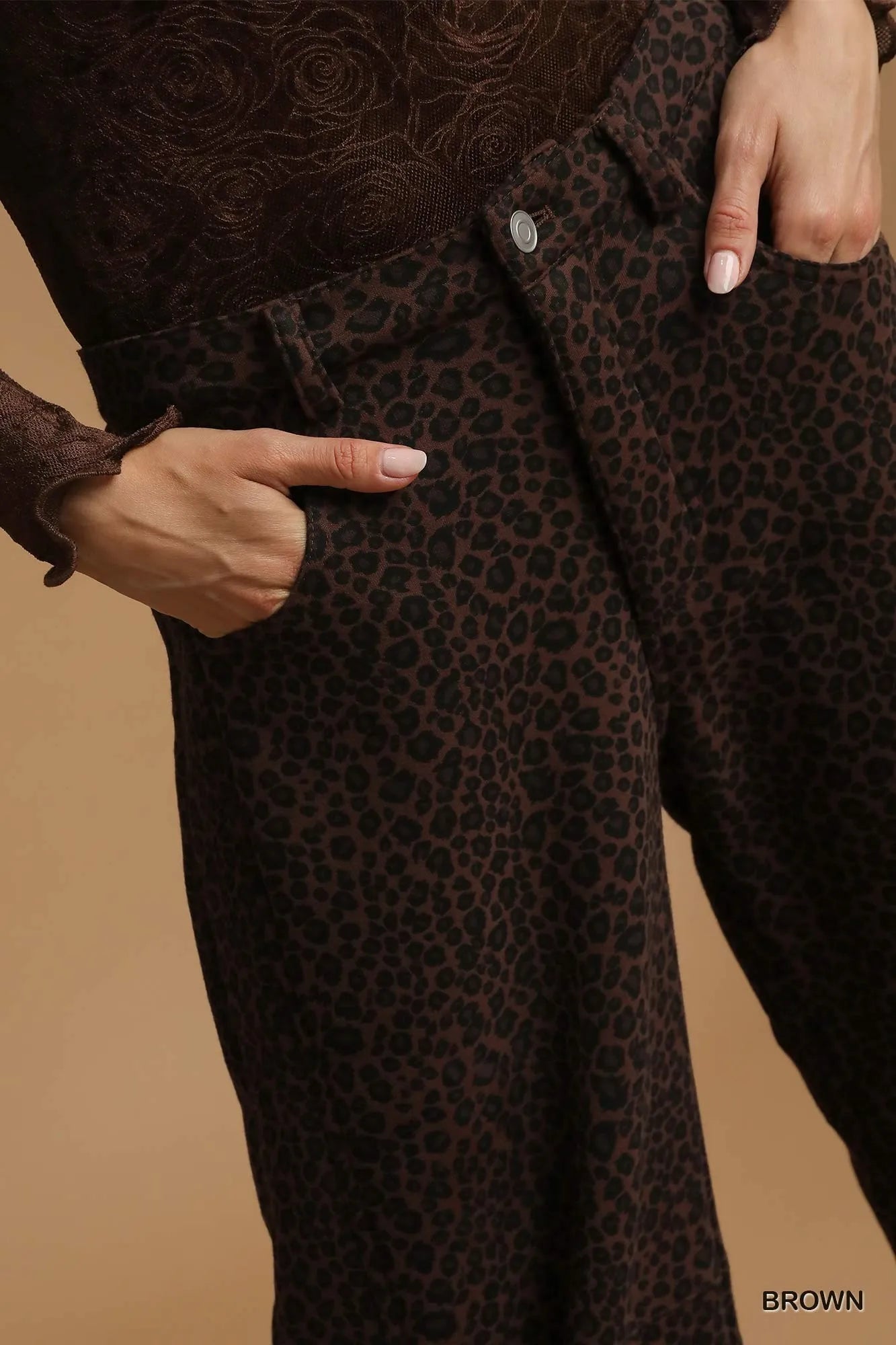 Close-up of Finley leopard print pants fabric showing cotton blend texture and pocket detail.