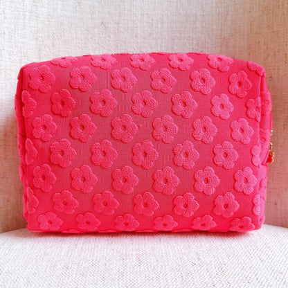 Pink Embossed Daisy Blossom Cosmetic Case with floral pattern and daisy zipper pull.