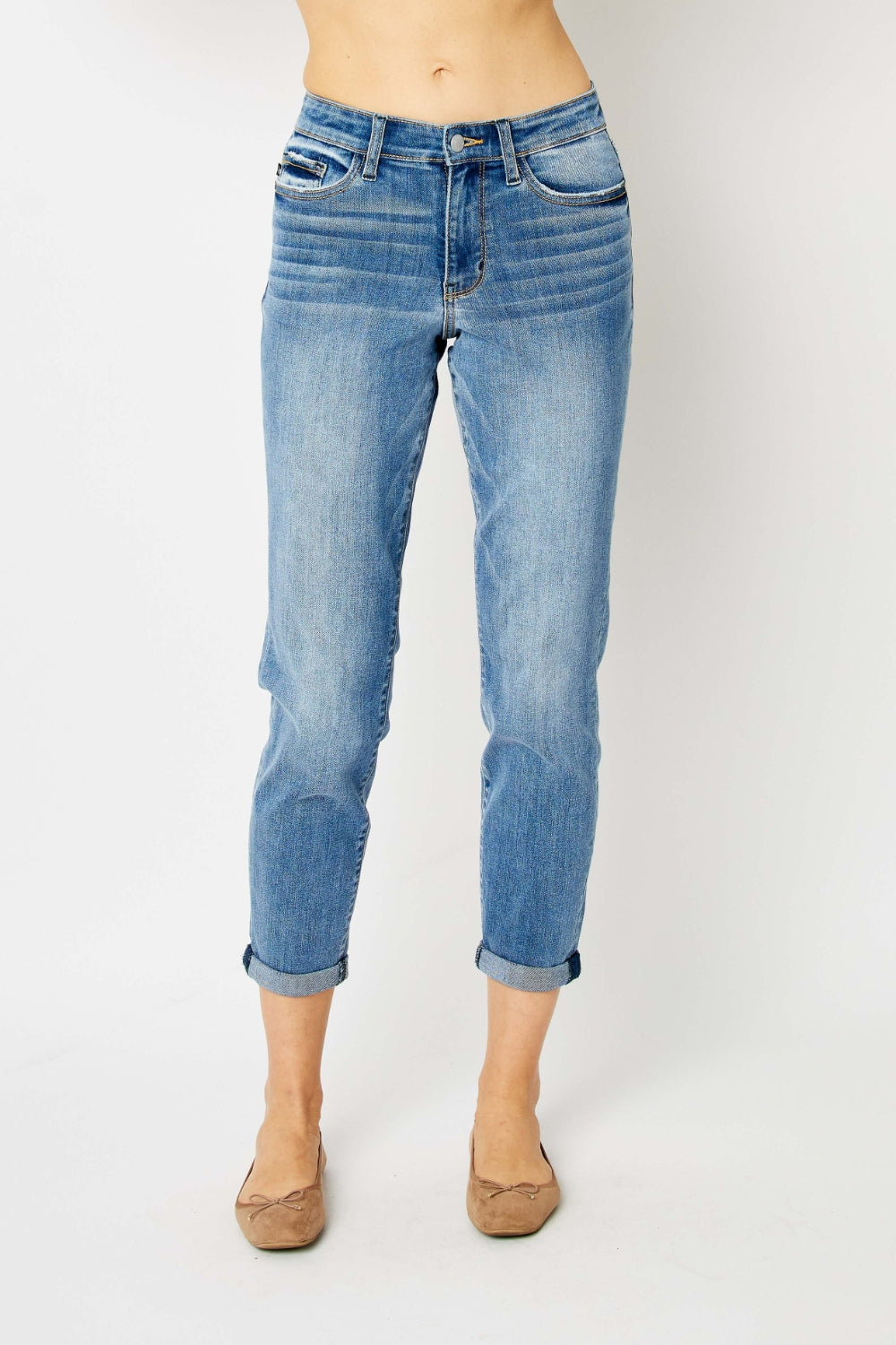 Mid-rise slim fit jeans with cuffed hems and a zip fly. Medium wash, highly stretchy fabric.