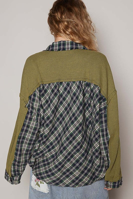 A women's button-down shirt featuring an olive green waffle knit with contrasting plaid accents, long sleeves, and a relaxed fit.