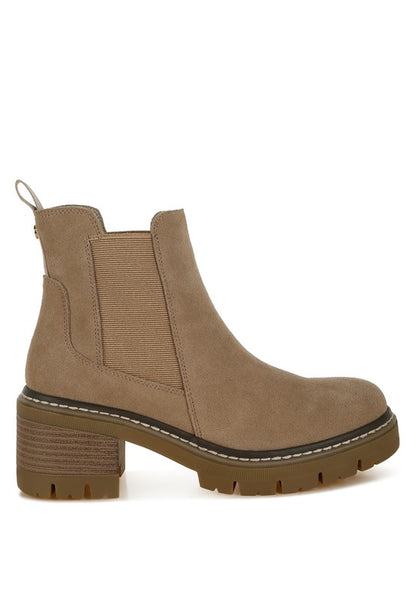 Profile view of beige suede Chelsea boots with 2-inch block heel