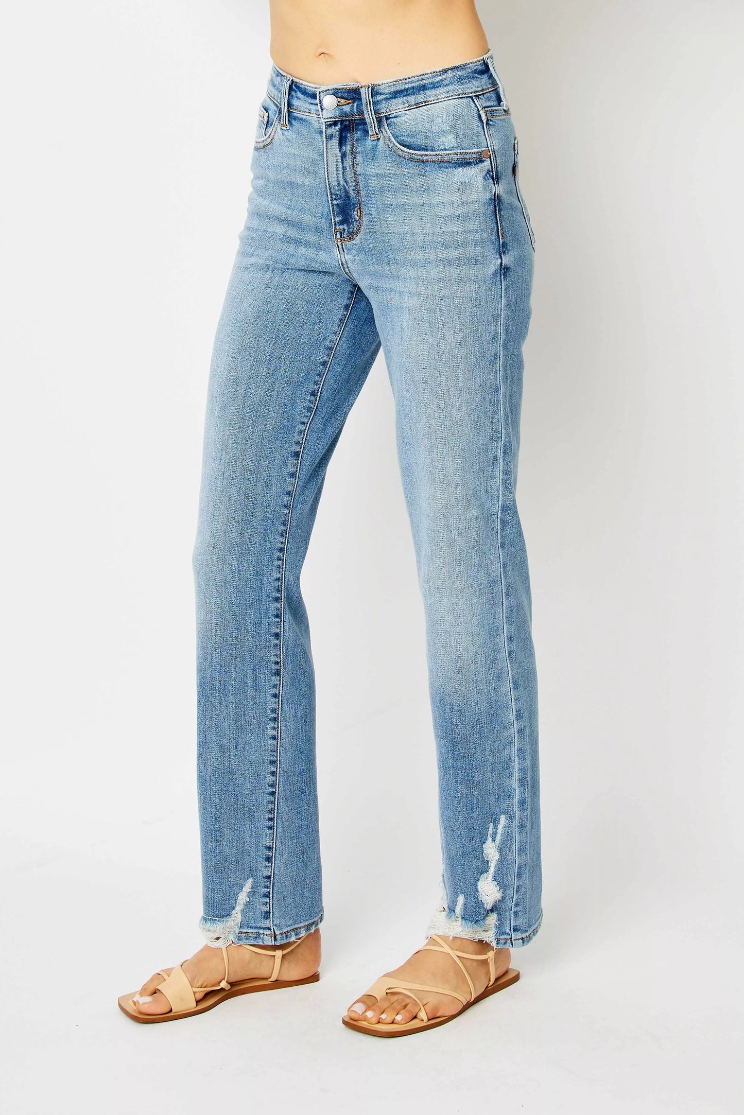Size inclusive model styling Judy Blue Estee high waist straight jeans in medium wash with destroy.