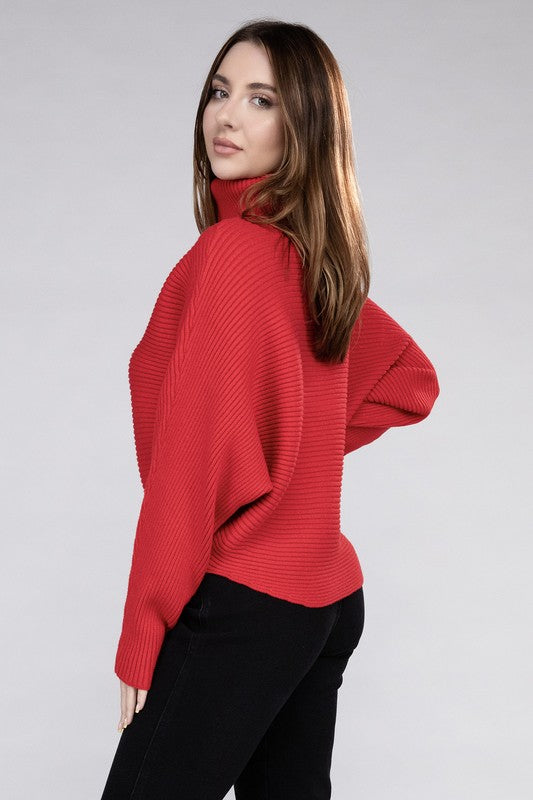 Ruby loose fitting turtleneck sweater, with ribbed knit texture, dolman sleeves, and raw hem detailing.