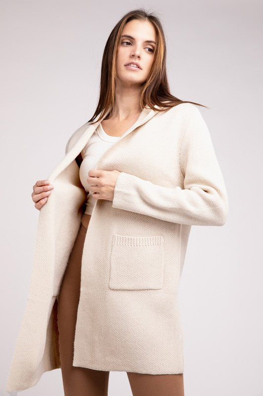 Sand Beige sweater cardigan with long sleeves, front pockets, and a hooded neckline. 