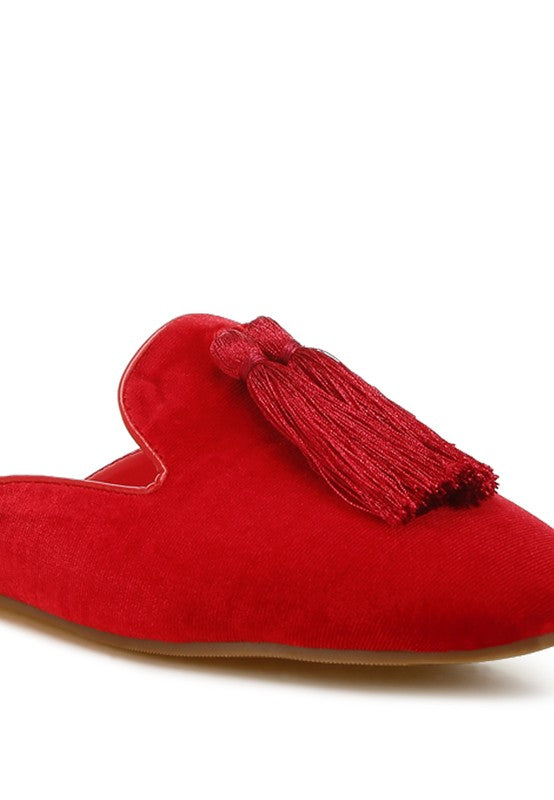 Red mules with velvet upper and tassel detail.