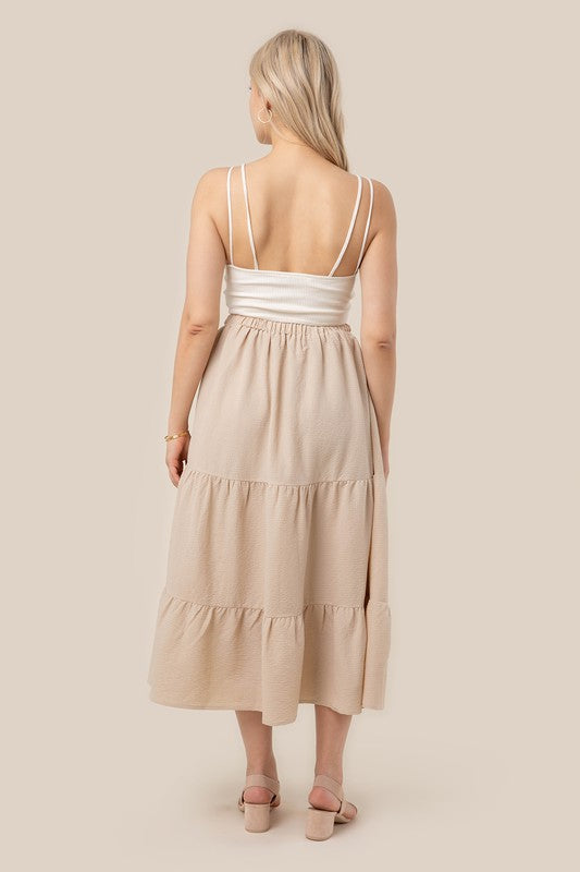 Tiered maxi skirt with elastic waistband in beige. Flowy silhouett, lined for full coverage.