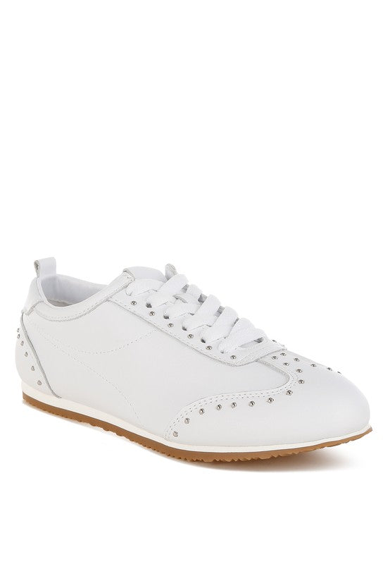 White Odaya Studded Leather Sneakers by Rag Company, front angle view showing stud embellishments and lace-up detail.