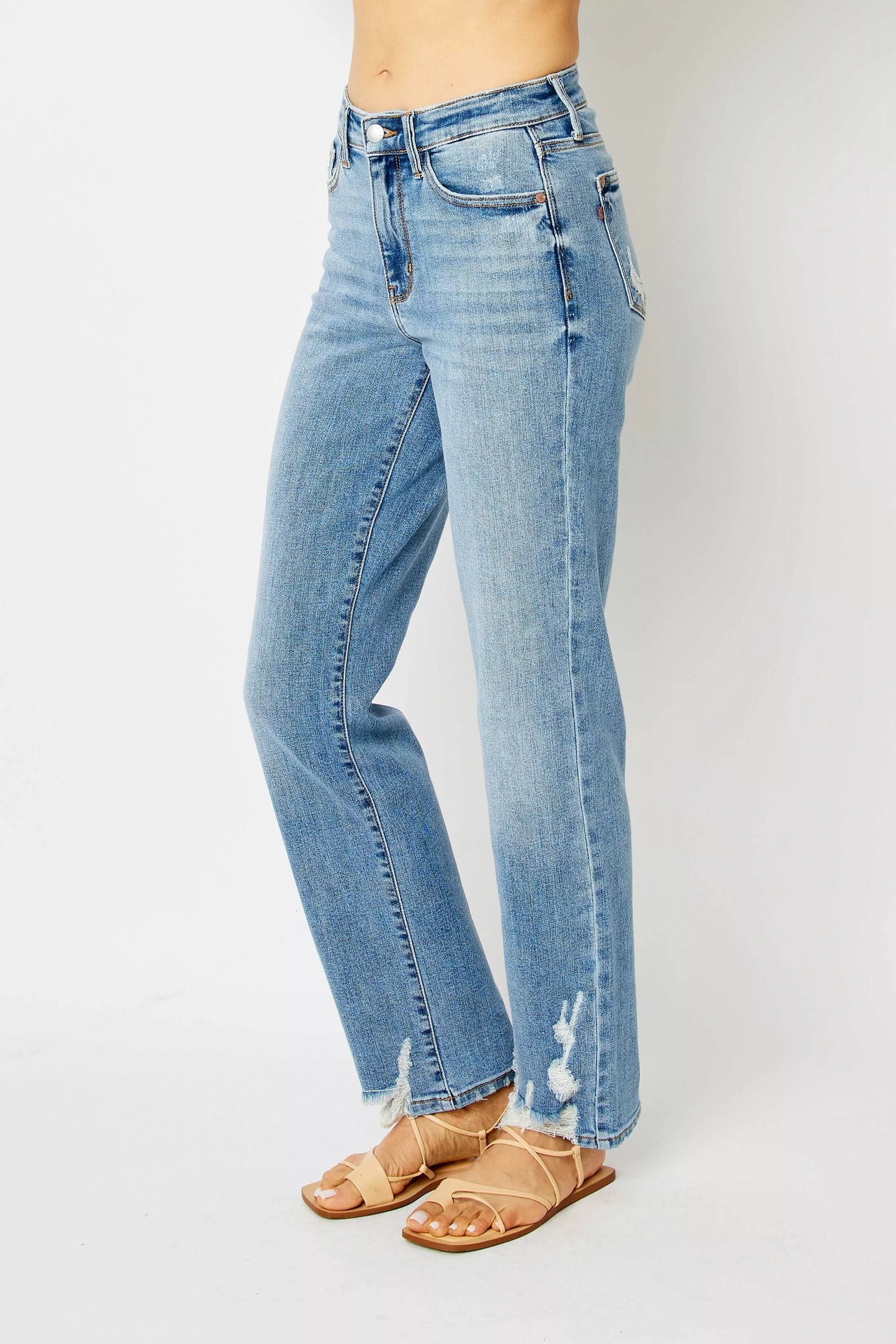 Side angle of Judy Blue Estee medium wash high waist straight jeans with distressed details.