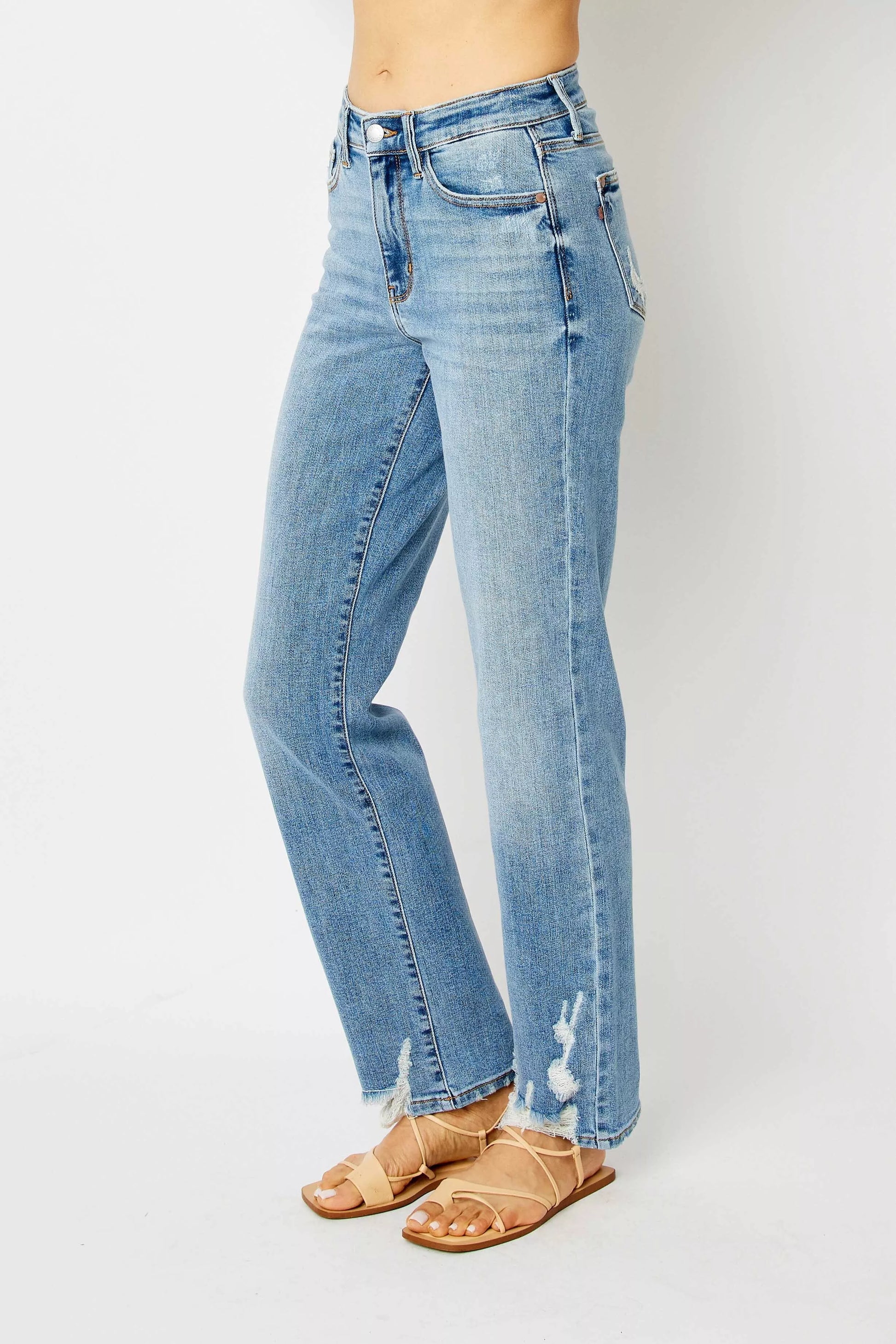 Side angle of Judy Blue Estee medium wash high waist straight jeans with distressed details.