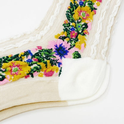 Close-up of embroidery on white Noble Floral Beauty Socks showing vibrant floral design.