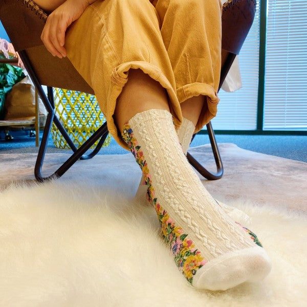 Woman wearing white Noble Floral Beauty Socks paired with casual outfit.