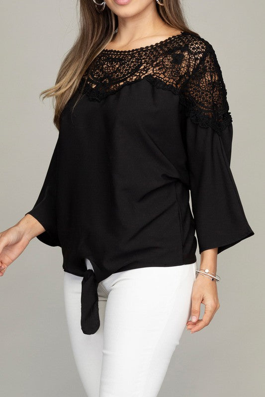 Solid black blouse featuring a round neckline with lace trim and three-quarter dolman sleeves.